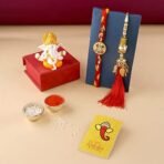 CraftVatika Rakhi Gift for Brother Bhabhi with Showpiece Combo Gift- Kundan Rakhi, Red Floral Lumba Rakhi for Brother Bhabhi with Figurine - Fast Shipping to USA & Canada