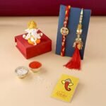 CraftVatika Rakhi Gift for Brother Bhabhi with Showpiece Combo Gift- Kundan Rakhi, Red Floral Lumba Rakhi for Brother Bhabhi with Figurine - Fast Shipping to USA & Canada