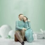 Xtore Beautiful Hand Painted Medium Size Resin Sitting Romantic Couple (Pack of 1, Multicolor) - Fast Shipping to USA & Canada